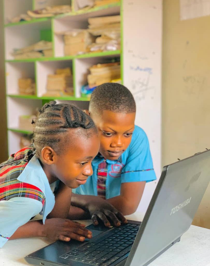 Primary pupils working together on a laptop